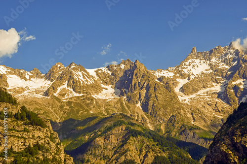 Scenic view of the Mont Blanc mountain range in the Graian Alps (Alpi Graie in Italian), view from the Alpine town of Courmayeur in a sunny summer day, Aosta, Aosta Valley, Italy