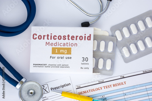 Corticosteroid medication or drug concept photo. On doctor table lies open packaging labeled 