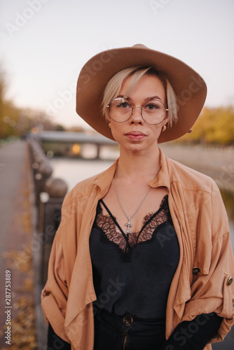 Fashionably hipstery dressed woman in the city streets, shopping concept. Photo with little cinema gain. photo