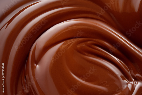 Chocolate background. Melted chocolate surface. Chocolate swirl.
