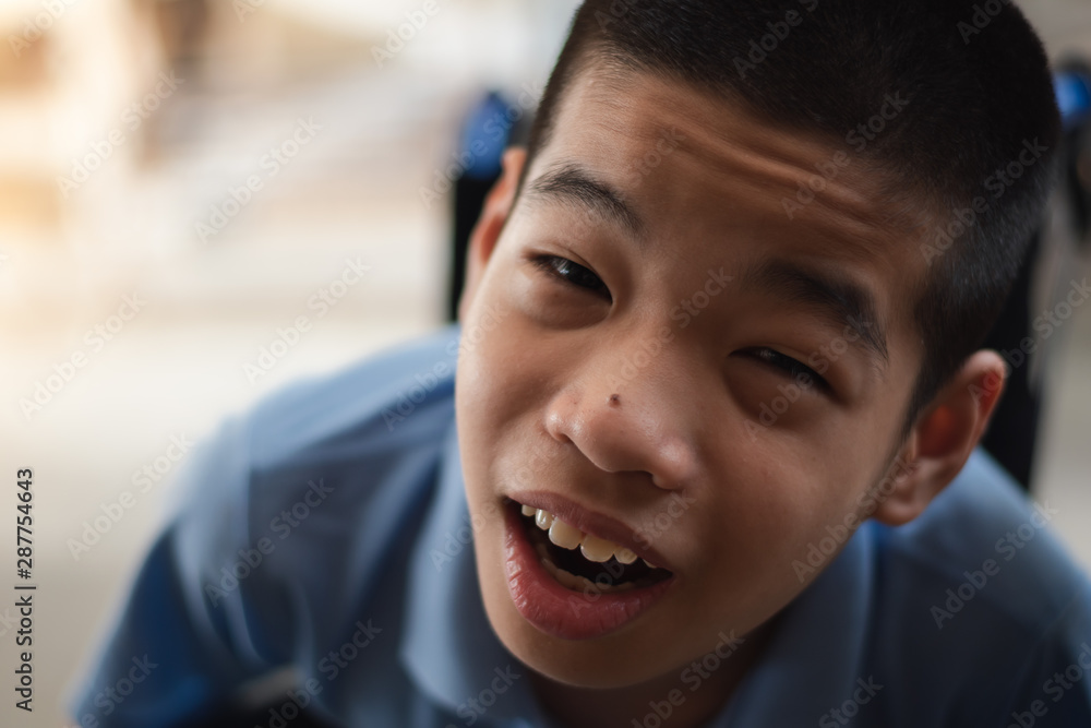 Disabled child on wheelchair is playing in the outdoor park like other people, He has adult to take care of closely, Life in the education age of special children, Happy disability kid concept. Disabled child on wheelchair is playing in the outdoor park like other people, He has adult to take care of closely, Life in the education age of special children, Happy disability kid concept.