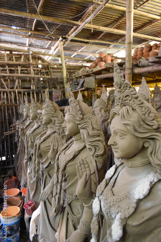 Clay idol of Goddess Devi Durga is in preparation for the upcoming Durga Puja festival at a pottery studio in Krishnanagar, West Bengal, India.