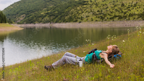 Photos Woman hiker enjoys resting in the beautiful nature.