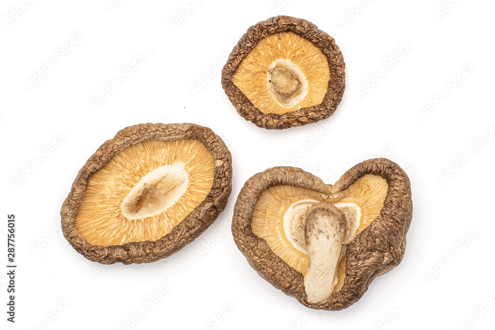 Group of three whole dry mushroom shiitake heart shape flatlay isolated on white background