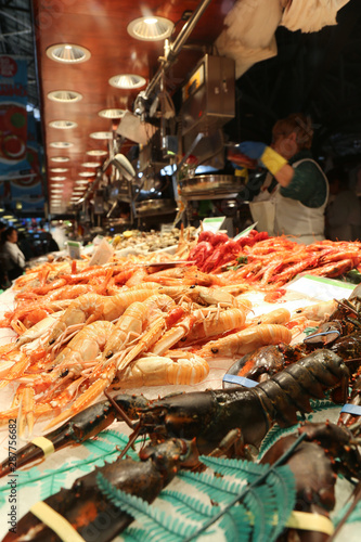 Fresh shellfish on the market desk. Lobsters, langoustine, shrimps, nephrons, prawns