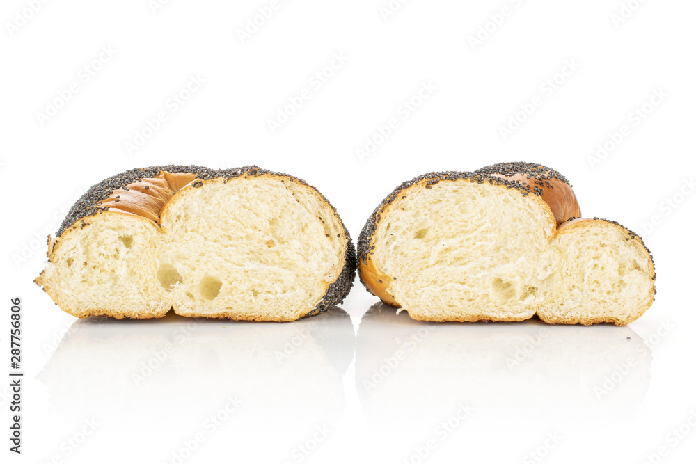Group of two halves of twisted poppy seed bun cross section isolated on white background