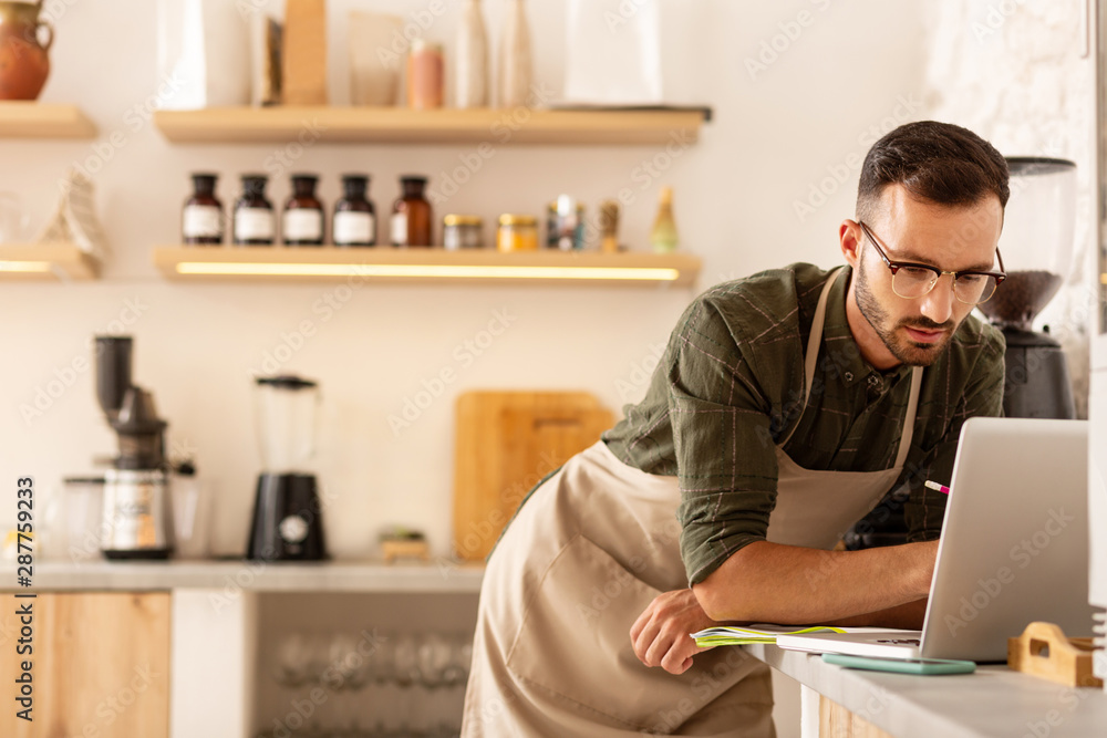 Dark-haired businessman ordering coffee online Dark-haired businessman ordering coffee online