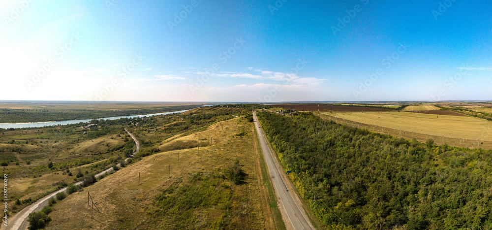 rural landscape with a road and a river. Aerial view (drone view) on a summer day in August above the right bank of the Don River near the place 