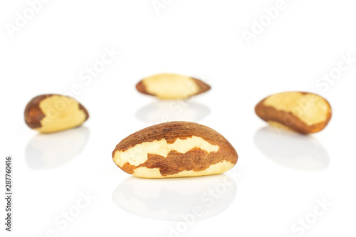Group of four whole raw brown brazil nut isolated on white background