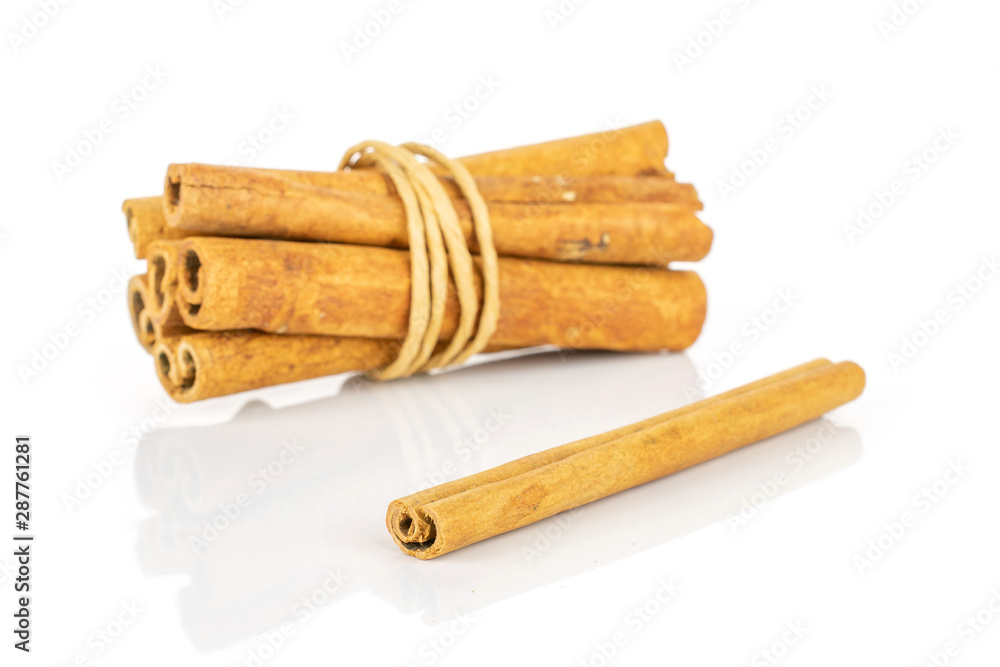 Group of seven whole dry brown cinnamon wrapped in natural twine isolated on white background Group of seven whole dry brown cinnamon wrapped in natural twine isolated on white background