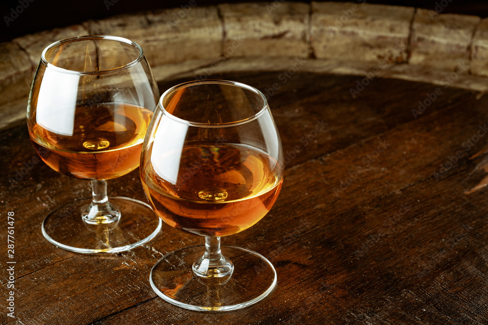 Two glasses of whiskey on a wooden table in the bar Two glasses of whiskey on a wooden table in the bar