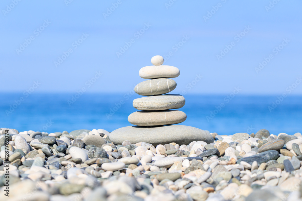 Stones balance on a background of sea. Calm and meditation. Concept of harmony and balance