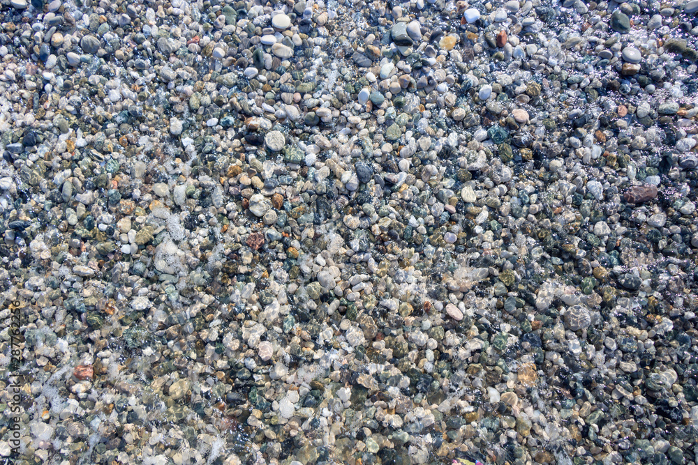beach colored pebbles in the sea, top view, background beach colored pebbles in the sea, top view, background