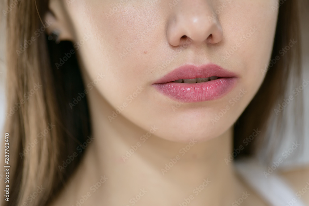 Beautiful female lips, close up. Selective focus. Beautiful female lips, close up. Selective focus.