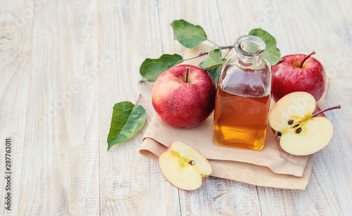 Apple cider vinegar in a bottle. Selective focus. photo