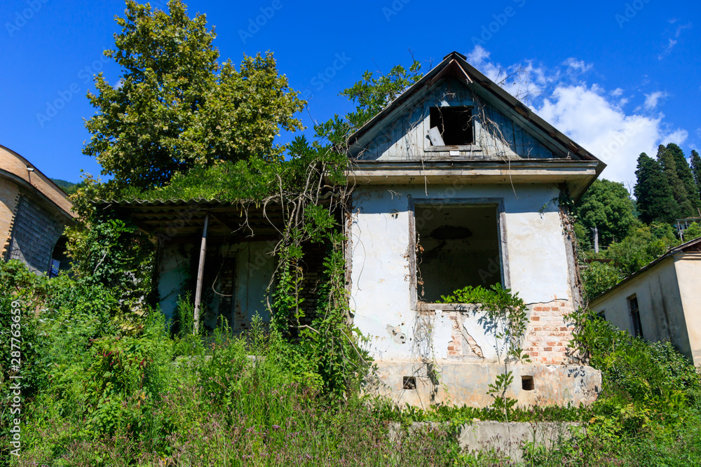 a crumbling old house with a grassy plot a crumbling old house with a grassy plot
