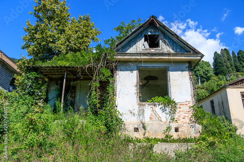 the abandoned house was overgrown with grass