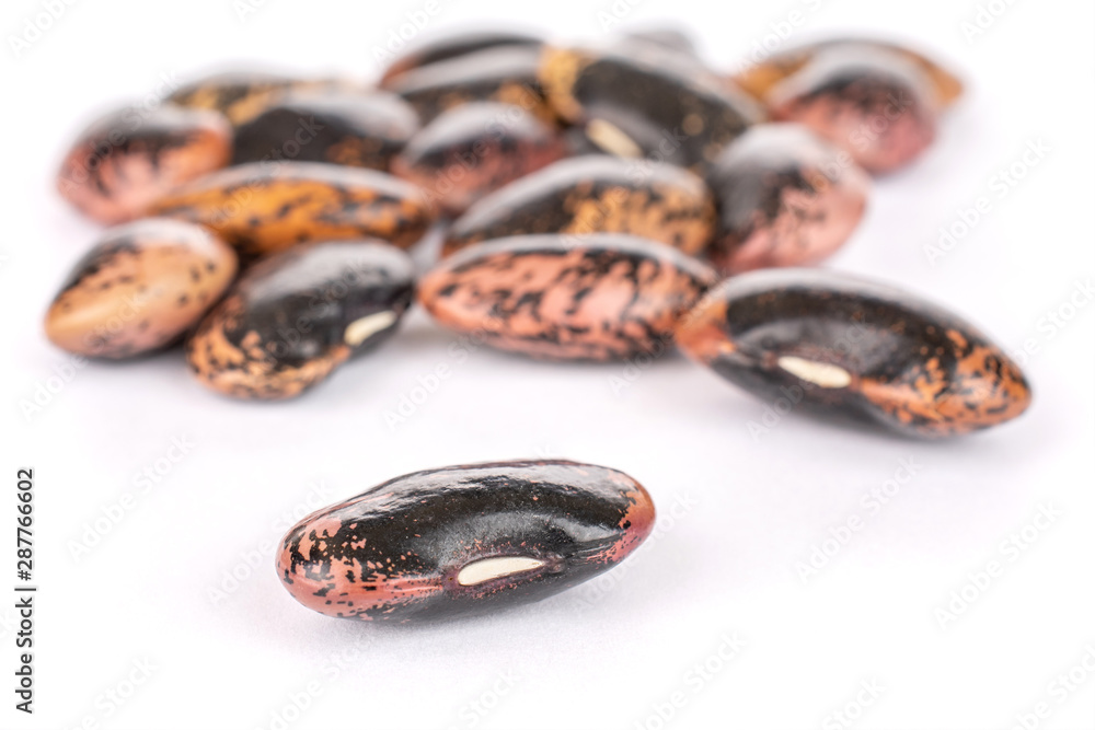 Lot of whole stained purple bean isolated on white background Lot of whole stained purple bean isolated on white background