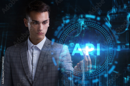 The concept of business  technology  the Internet and the network. A young entrepreneur working on a virtual screen of the future and sees the inscription  API