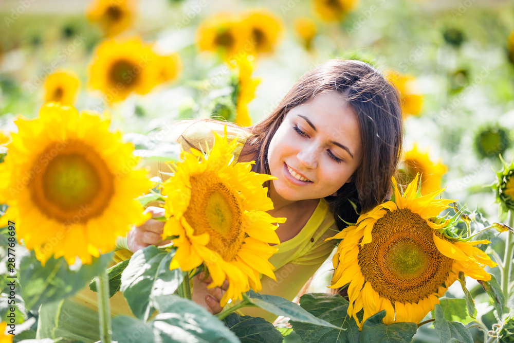 happy young girl in a field with sunflowers happy young girl in a field with sunflowers