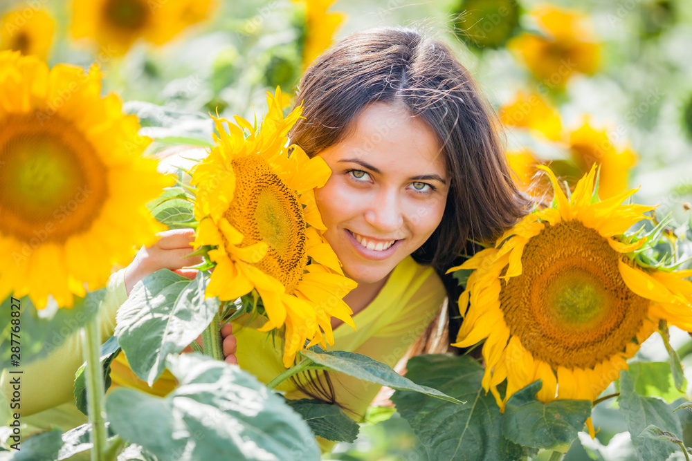 happy young girl in a field with sunflowers happy young girl in a field with sunflowers
