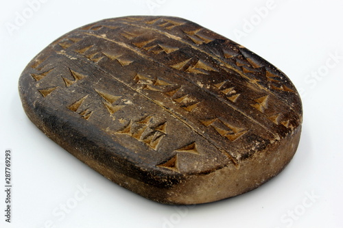 Картината върху платно cuneiform tablet with words letters and writing on isolated on white background