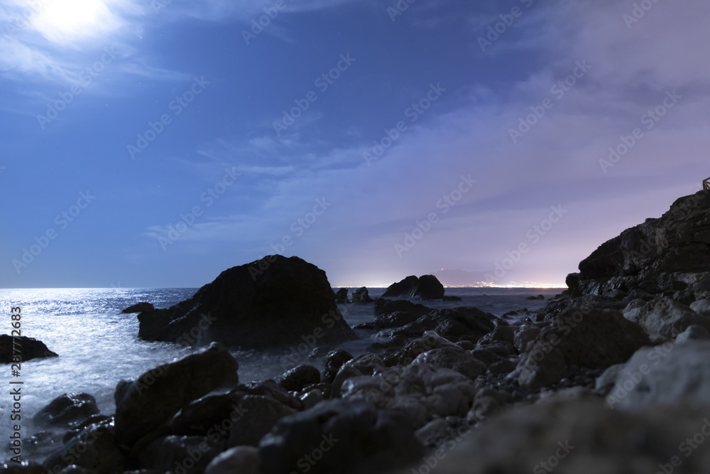 Seaside landscape in the night with rocks