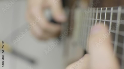 Playing guitar 4K. Close up of left hand