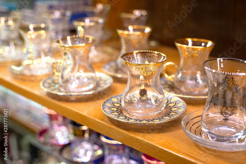 Traditional famous turkish tea cup with plate on the shelf in the shop. One of the most popular souvenir from Istanbul  Turkey.  