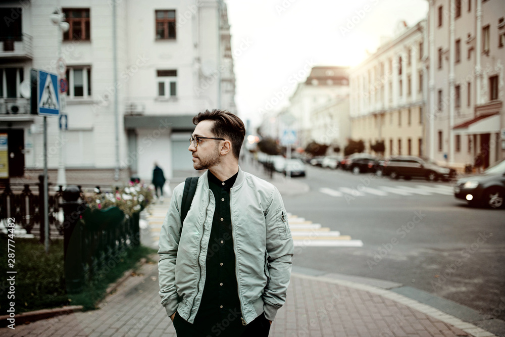 male traveler walks around the old city and studies the classical architecture of Europe male traveler walks around the old city and studies the classical architecture of Europe