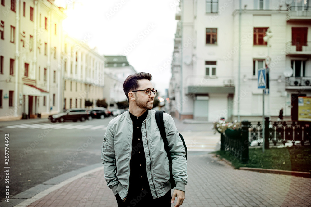 male traveler walks around the old city and studies the classical architecture of Europe male traveler walks around the old city and studies the classical architecture of Europe