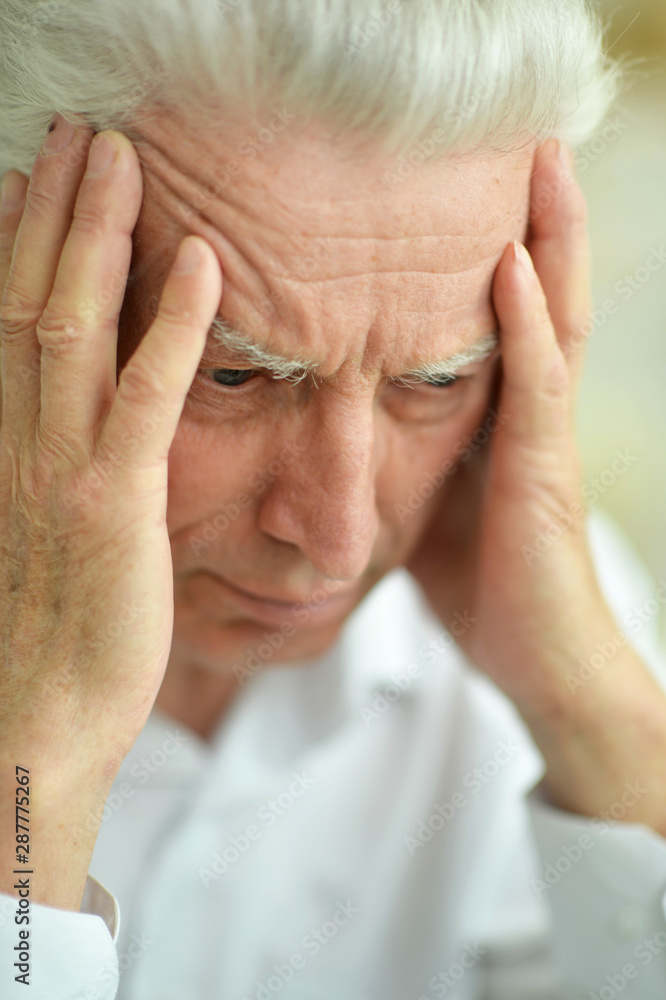 Beautiful sad thinking senior man posing at home Beautiful sad thinking senior man posing at home