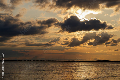 Fototapeta Naklejka Na Ścianę i Meble -  Sunset with black clouds on the Amur River