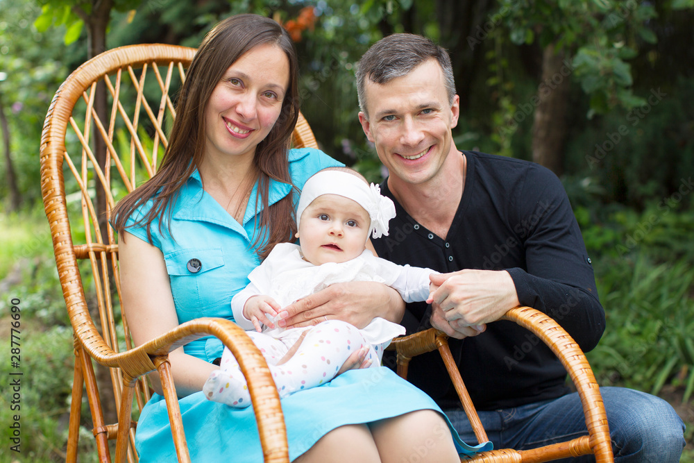 Obraz premium Family portrait mom dad and little baby. Parents with baby