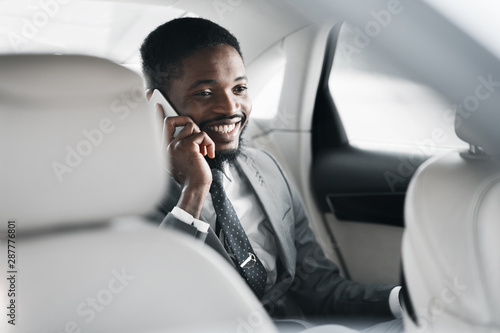 Successful businessman talking on phone in car © Prostock-studio