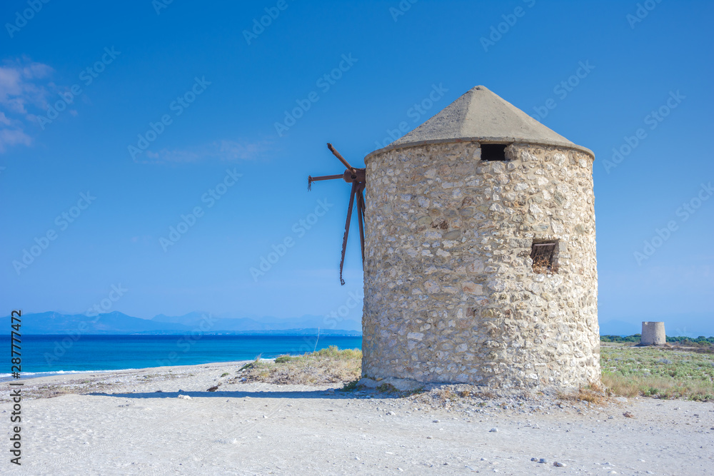 Famous Gyra beach with old windmills in Lefkada island, Greece.