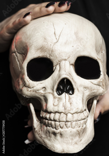 Close-up of woman holding cranium