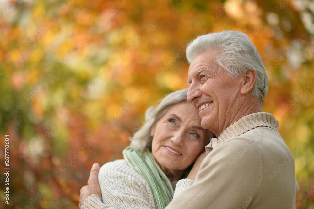 Happy senior couple in autumn park hugging Happy senior couple in autumn park hugging