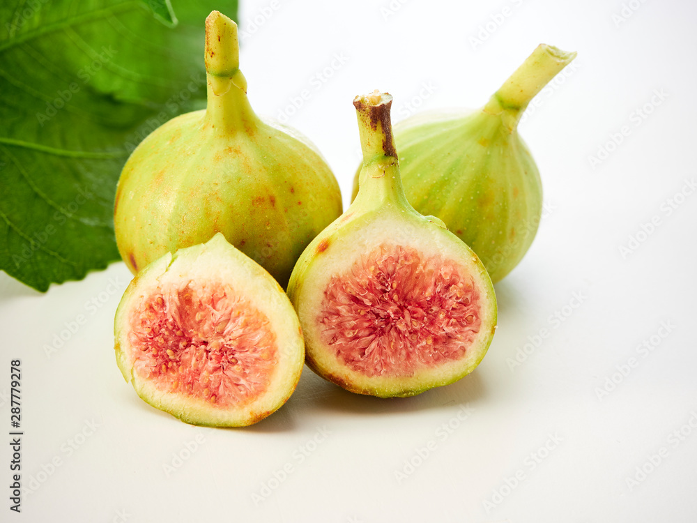 Figs fruit with leaves on white background Figs fruit with leaves on white background