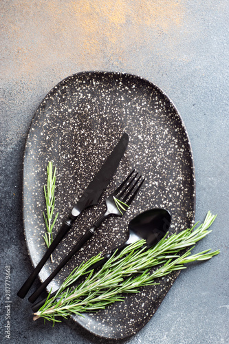 Table setting with ceraic plates and rosemary photo