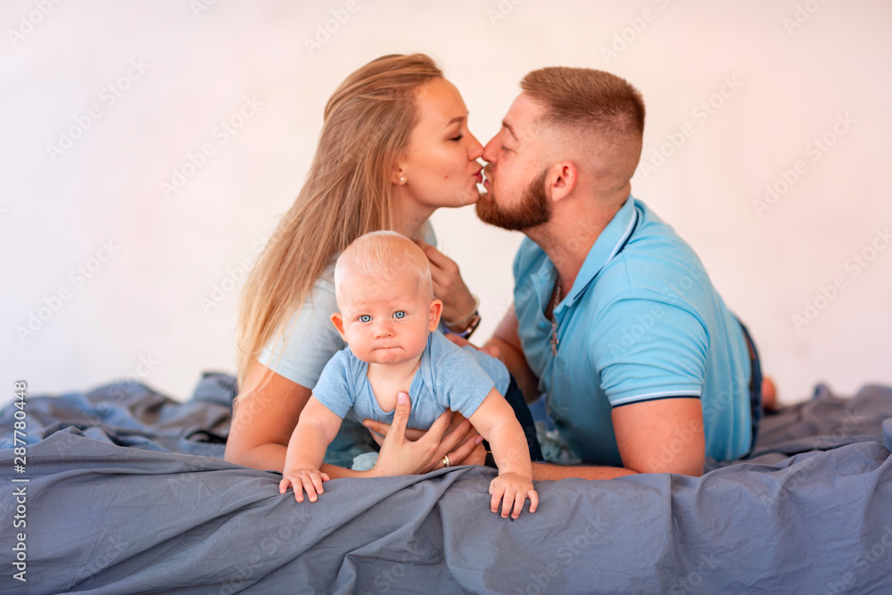 Young happy family with the baby indoors Young happy family with the baby indoors
