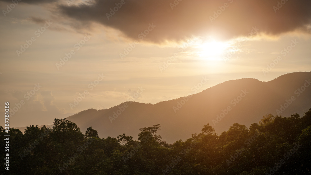 Rain on the mountains with warm light.