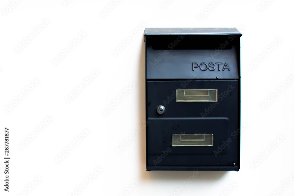 Black post box in cement wall Black post box in cement wall