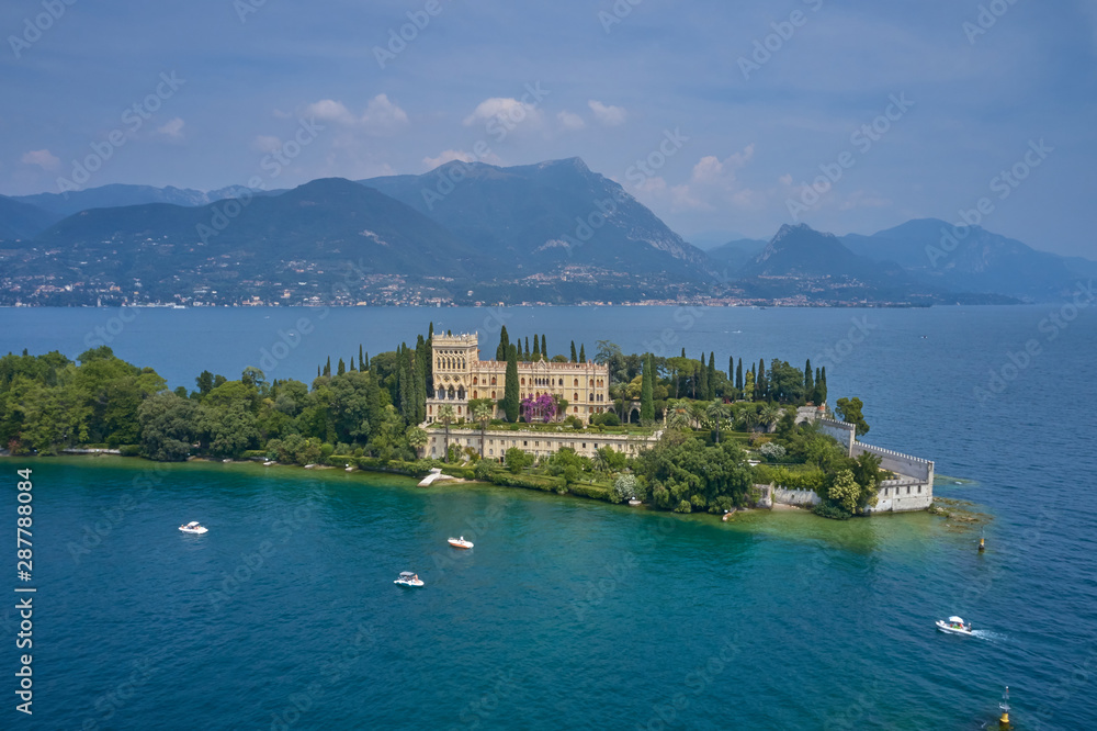 Unique view of the island of Garda. In the background is the Alps. Resort place on Lake Garda north of Italy. Aerial photography.