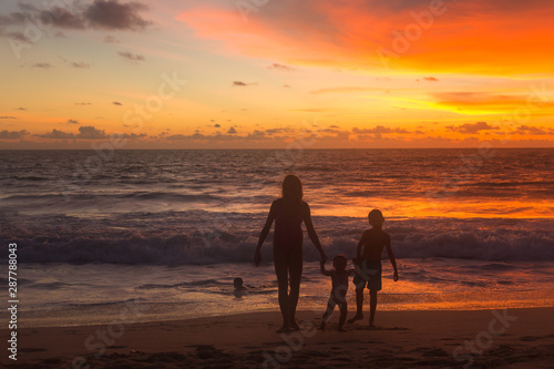 family on th beach at sunset