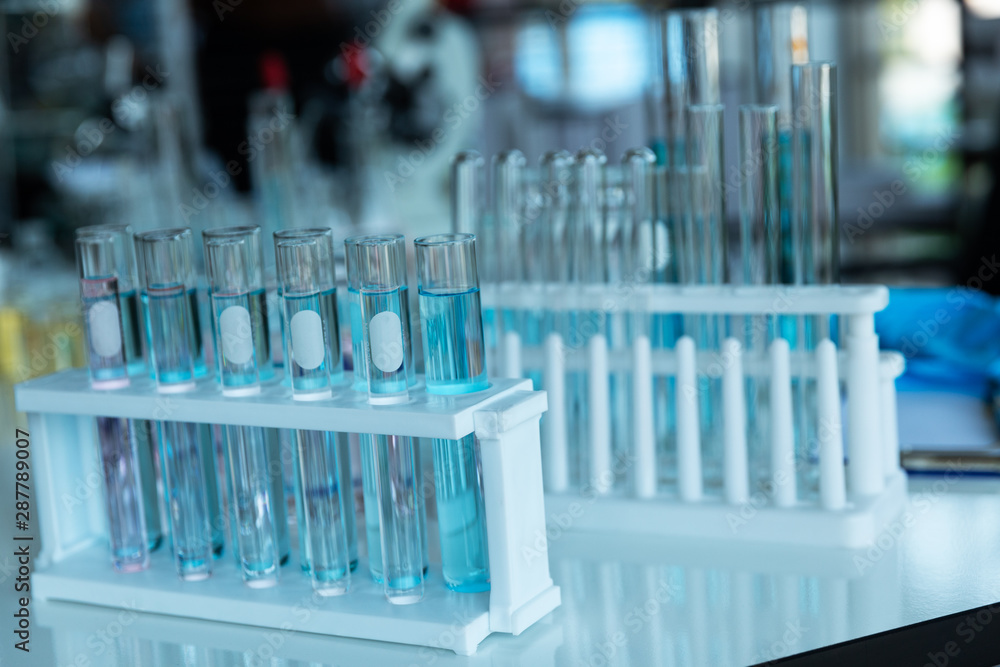 In lap at school,university,science chemistry concept. Laboratory test tubes and flasks with color liquid put on white table for work,check and test chemistry. In lap at school,university,science chemistry concept. Laboratory test tubes and flasks with color liquid put on white table for work,check and test chemistry.