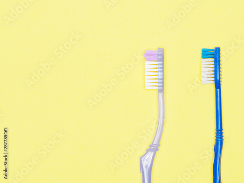 Toothbrushes on yellow background. Dental care concept