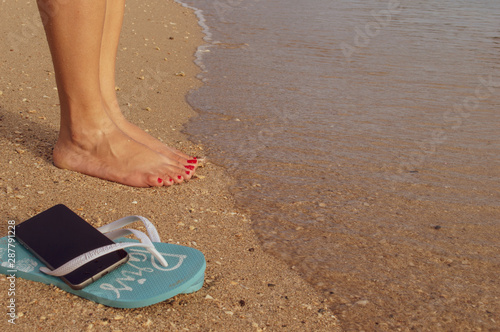 feet in sandals on beach