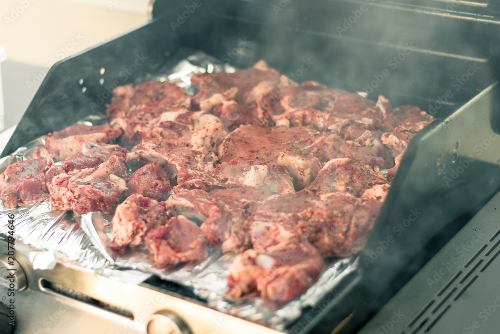 Cooking meat on the grill. The process of making grilled meat. Raw meat on the grill Cooking meat on the grill. The process of making grilled meat. Raw meat on the grill