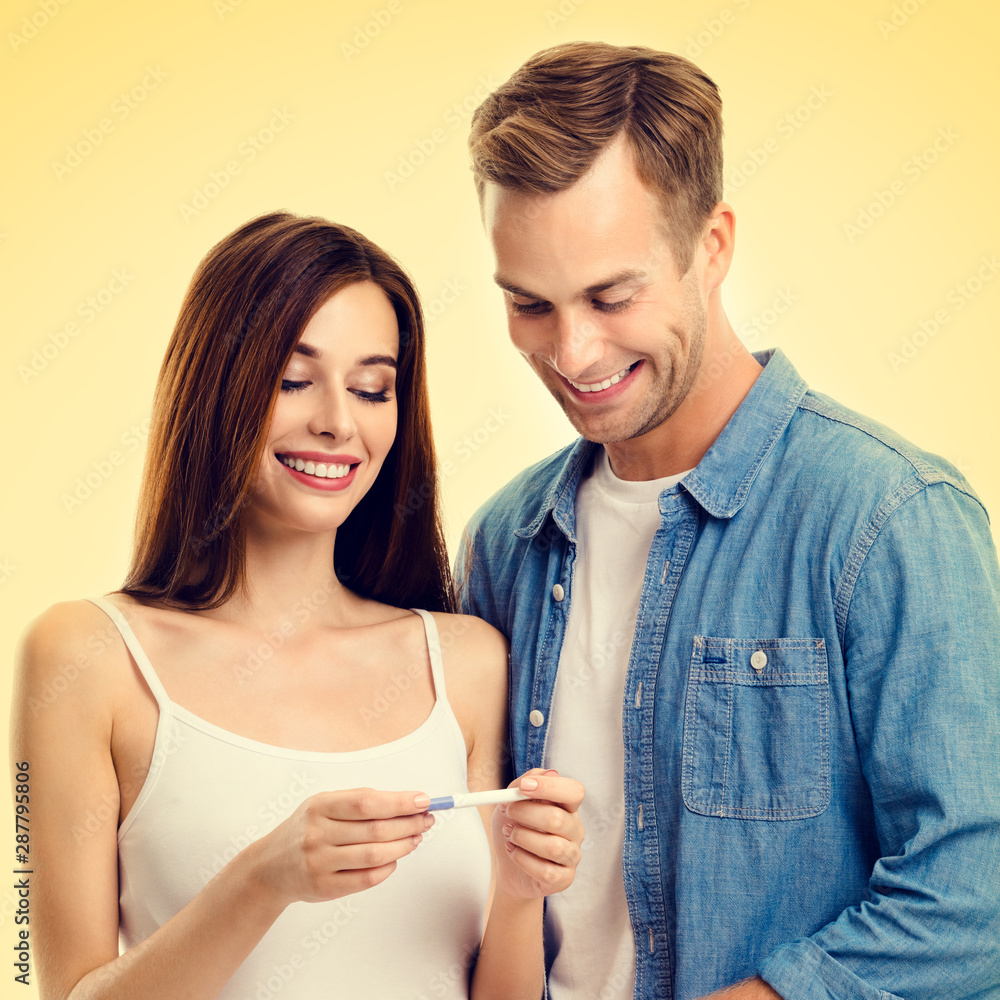 Square composition picture of couple, finding out results of a pregnancy test Square composition picture of couple, finding out results of a pregnancy test